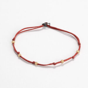 Cord bracelet with gold beads
